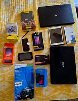 Entire lot overview showing laptops, tablet, phones, accessories