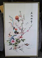 Full view of framed artwork showing birds, blossoms, sunset and calligraphy in gold-tone frame