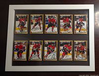 Front view of framed display showing all ten signed cards