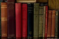 Row of spines showing titles such as Captain Ravenshaw, Representative One-Act Plays, Pastoral Theology, Milton volumes