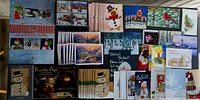 Overall view showing four boxed sets and numerous loose Christmas cards spread out