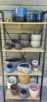 Full view of shelving unit displaying all planters on four shelves