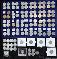 Overview of entire lot showing tray of dated compartments, flipped coins and holdered 1967 piece