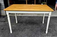 Full view of rectangular oak top table with white legs