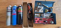 Overview of cylinders, boxed soldering iron and open toolbox kit