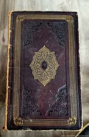 Front cover showing full-leather binding, gilt tooling, wear on edges