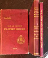 Front covers of the three hardcovers standing side by side