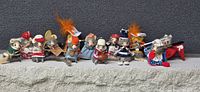 All 14 fur mouse figurines lined up on ledge