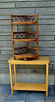 Rattan corner shelf positioned on top of wood side table, full view