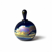 Front view showing spherical cobalt blue perfume bottle with stopper and iridescent sheen