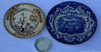 Three pieces laid out: oval Indian Tree plate, round blue British Lakes platter, small Selborne saucer