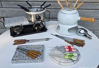 Both fondue sets, granite stones, forks and accessories overview