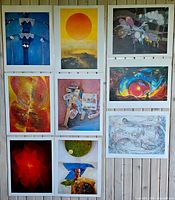 Nine lithograph prints displayed on vertical surface