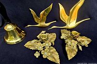 All five brass items grouped on dark background