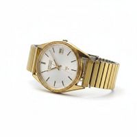 Angled view of the gold-tone Seiko Quartz wristwatch showing dial and expansion band