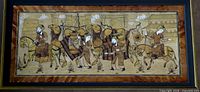 Close view of miniature painting showing caravan figures and animals
