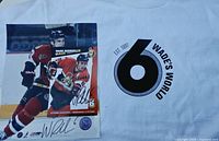 Signed 8x10 photo beside Wade’s World T-shirt