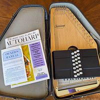 Autoharp in open case with two manuals visible