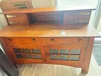 Front view showing drawers, lower grille doors, upper shelf and small doors