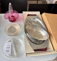 Group shot showing pink basket, divided plate, two clear bowls, metal tray with glass insert