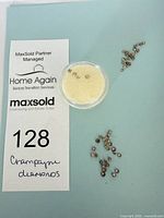 Lot overview with container and loose diamonds on card