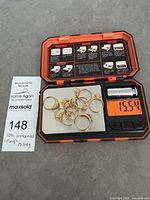 All rings on digital scale showing 15.54 g total weight