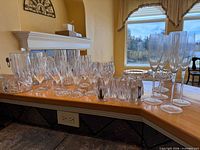 Group view of all cut glass stemware and serveware on countertop
