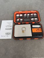 Ring on digital scale showing weight and lot card