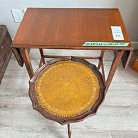 Top view of drop-leaf table beside round pedestal table