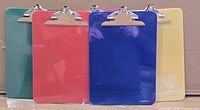 Front view of five colored clipboards