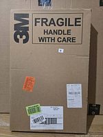 Sealed 3M shipping carton indicating fragile handle with care