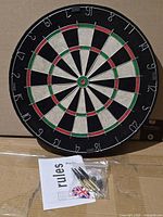 Front view of 18-inch dartboard with accessories below