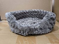 Full view of grey oval plush pet bed