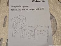 Instruction sheet showing assembled castle-style rabbit house