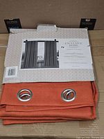 Front of packaged curtain panels showing color, texture and grommets