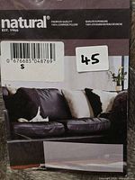Front of packaged Natural Rugs Torino cowhide pillow
