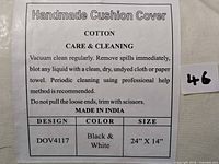 Close-up of care and cleaning label showing material cotton and handmade cushion cover details