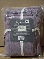 Front view of sealed lavender Talesma towel set