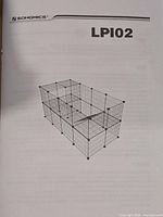 Instruction manual cover showing assembled rectangular wire grid playpen model LPI02