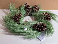 full view of wreath showing needles and pinecones