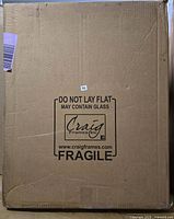 Sealed Craig Frames Inc. shipping box labeled fragile and may contain glass