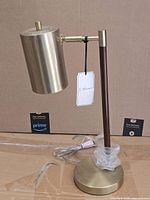 Full view of brass table lamp with base, stem, shade and cord