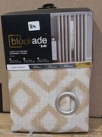 Front of retail package showing VCNY Blockade Nyack grommet panel with fabric sample and grommet visible