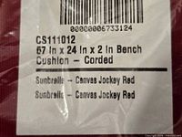 Close-up of product label showing model CS111012, dimensions, color, and Sunbrella fabric details