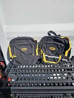 Front view of both Bell panniers showing color, zippers, reflective strip