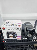 Retail box and Bosch Tassimo T65 brewer on rack