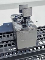 Front view showing Acoustimass subwoofer with two satellite speakers placed on top