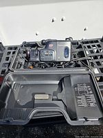 Open carry case showing Canon E61 camcorder, cables, interior layout