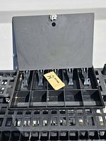 Cash box open displaying bill clips, coin compartments and keys