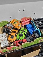 Top view of assorted die-cast vehicles in box